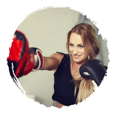 Teenage girl punching punchbag