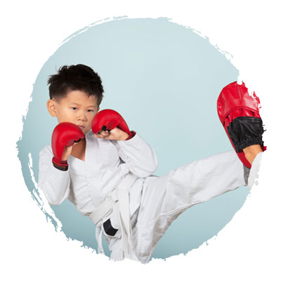 Two young boys sparring in Karate class